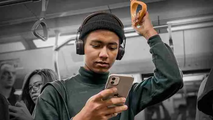 A person viewing their phone on a train