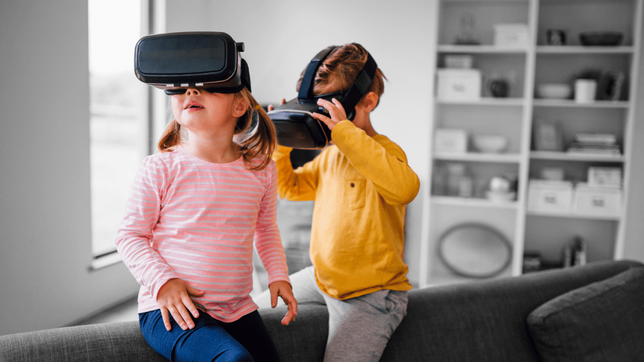 Two small children playing with a virtual reality set