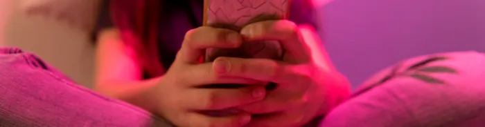 Teen's hands holding a phone
