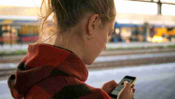 Teenager holding phone: Meta is harming people's mental health